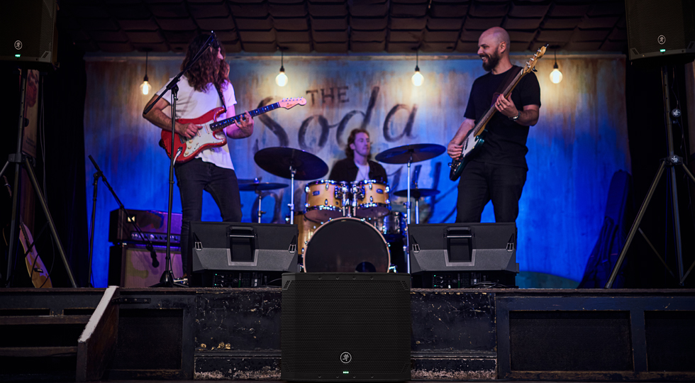 Band performing on stage using Thumpv4 subwoofer and loudspeakers.